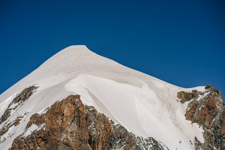 The summit of Pollux peak, Vallais, Switzerland. High alpine summit with glacier, ice and snow. Blue sky and snow peak in Monte Rosa masiff, Zermatt.の写真素材