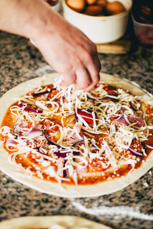 A closeup of a man preparing a pizzaの写真素材