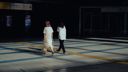 The two women walking in the street.の写真素材