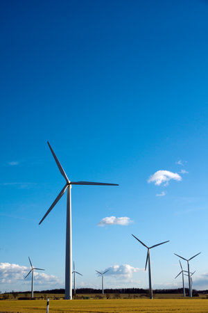 A vertical photo of windmills on a field