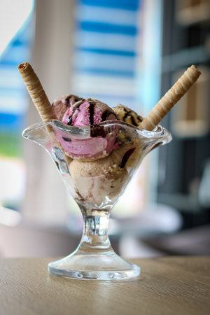 A vertical shot of a delicious ice cream snack with different flavors and chocolate sticks