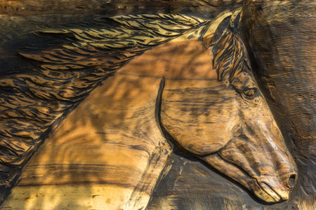 A closeup of a carved wooden horse headの写真素材