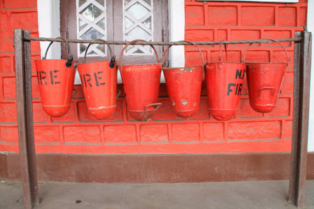 A closeup of vibrant red fire extinguishing buckets of sand in Darjeeling, Indiaの写真素材
