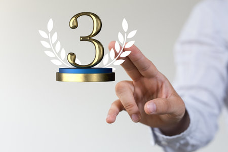 A shallow focus shot of a human hand pointing at third place prize - competition concertの写真素材