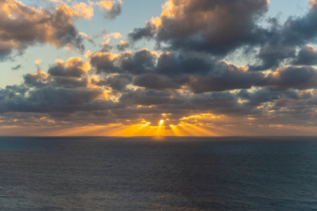A beautiful view of an ocean with colorful sunset