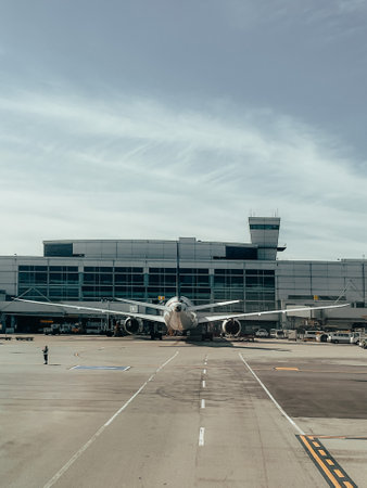 A vertical shot of a parked airplane during the dayの写真素材