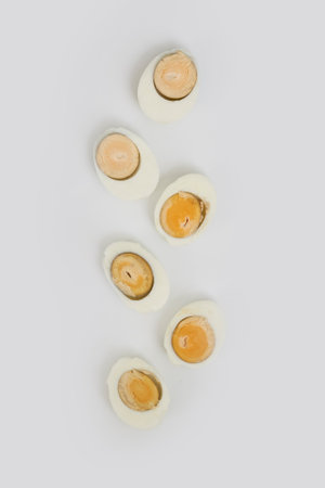 A top view of the boiled eggs cut in pieces on a white surfaceの写真素材