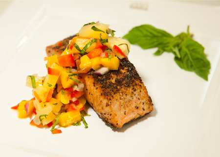 A serving of salmon steak with vegetablesの写真素材