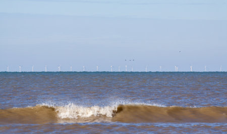 Off shore wind park near the coast of the Netherlands (Katwijk), barely visible in early morning lightの写真素材