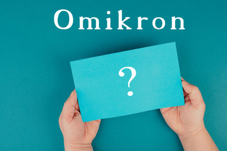 The german word for omicron is standing on a paper, new covid-19 variant from south africa, pandemicの写真素材