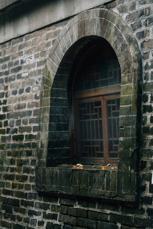 A vertical shot of an old stone wall with weathered walls