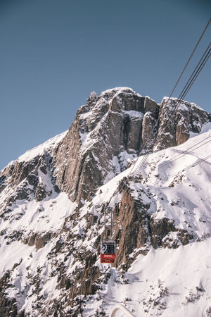 A vertical shot of the funicular on the background of snowy rocks in Chamonixの写真素材