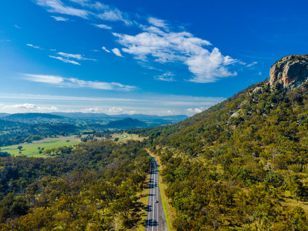Aerial View at Bluff Rock with big beautiful green mountains and blue sky and a car rowed in the middle in Australiaの写真素材
