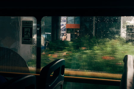 A closeup of a bus window with nature backgroundの写真素材