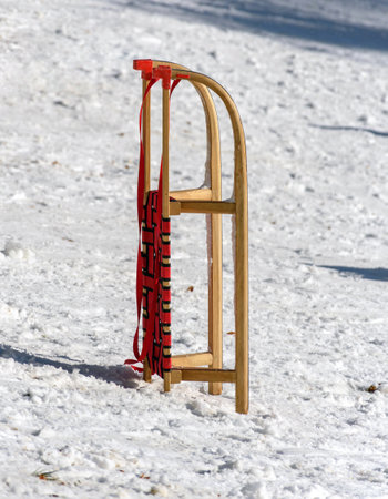 A view of a wooden sled on a snow on a sunny winterの写真素材