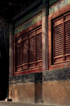 A vertical shot of an old building with weathered windowsの写真素材