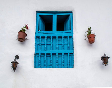 Old blue window of a house in the city of Cusco.