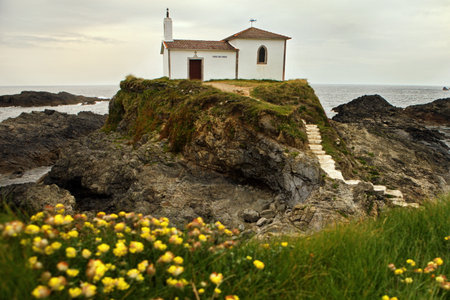 A house on a rocky shore in Spain during daylightの写真素材