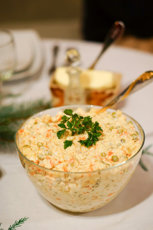 A vertical shot of a traditional polish christmas salad in a glass jarの写真素材