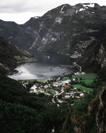 A breathtaking view of rocky mountains and the channel captured from the field on the peakの写真素材