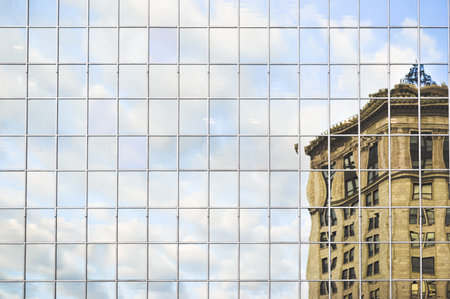 A reflection of a building on an another building with all glass windowsの写真素材