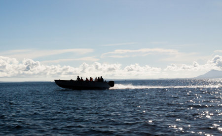 Silhouet of a water taxi at high speed between the isle of Nosy Be and mainland Madagascarの写真素材