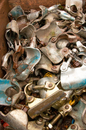 A background pile of scaffolding metal connectors