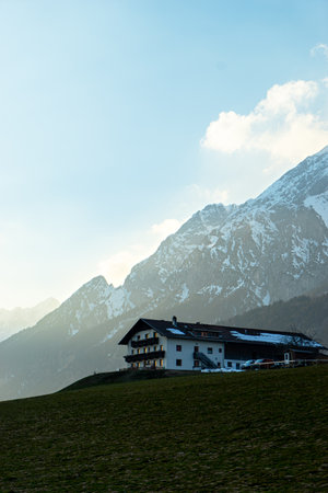 A mesmerizing view of the building with the Austrian Alps in the background against a cloudy skyの写真素材