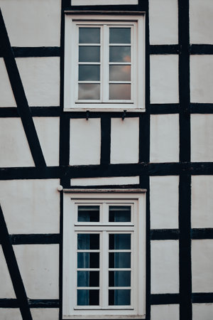 A vertical closeup of an old white building with windowsの写真素材