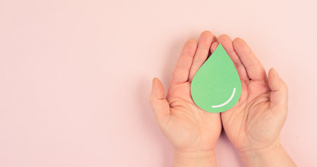 Holding a green drop, olive oil, alternative bio fuel, recycling resourses, sustainability lifestyle, ecology conceptの写真素材