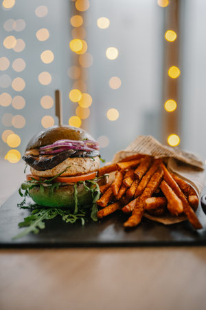 Tasty burger with fries served at the cafeの写真素材