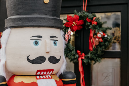 A closeup of a big nutcracker soldier with Christmas decorations