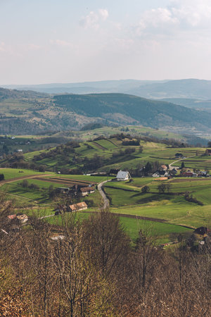 A vertical view near Hrinova village in Slovakia of small fields and cottages and houses
