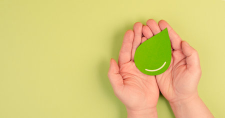 Holding a green drop, olive oil, alternative bio fuel, recycling resourses, sustainability lifestyle, ecology conceptの写真素材