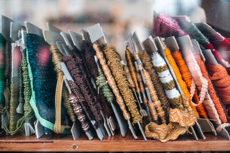 A closeup photo of fabric trims and borders on a shelf