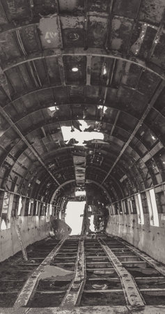 A grayscale vertical interior of a crashed navy