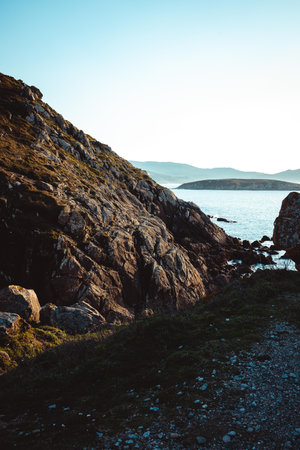 A vertical shot of a beautiful view through the rocks to the seaの写真素材