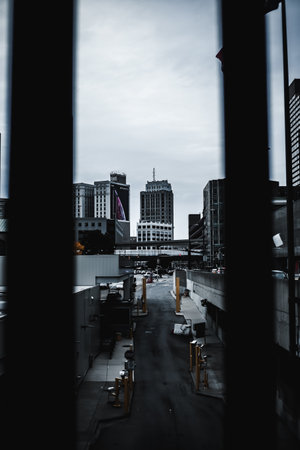 A vertical shot of an urban scenery with skyscrapers and tall buildings taken from a window or...