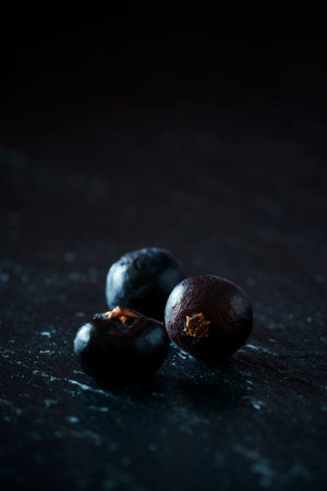 A vertical shot of blueberries on a dark background