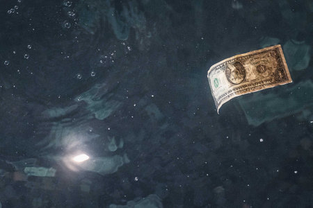 A one dollar bill floating in waterの写真素材
