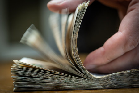 man checking money bills on the table