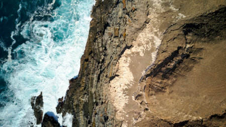 Overhead shot photo of rocks and sea blue wavesの写真素材