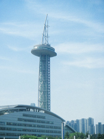 A vertical shot of the Long Ta Tower in Harbin, China against a light blue sky