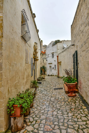A small street between the old houses of an ancient city in the Basilicata region.