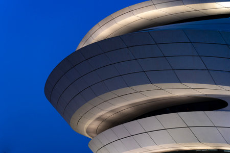 A beautiful exterior scene of the Meixi Lake Theater in Changsha, China against a blue skyの写真素材