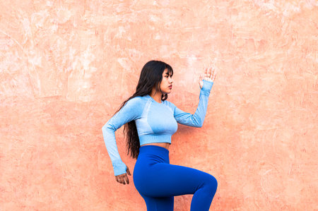 A Attractive Colombian woman dressed in sportswear, doing physical exercises in a parkの写真素材