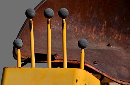 Gear controls on an old rusted tractor.