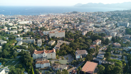 An aerial shot of a town with hotels and guest houses surrounded by trees with the sea in the backgroundの写真素材