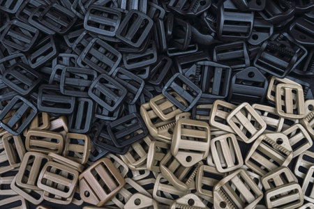 A closeup of a pile of belt buckles