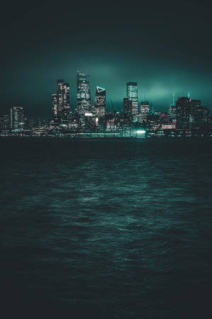 A vertical shot from the sea of skyscrapers in the nighttime.の写真素材